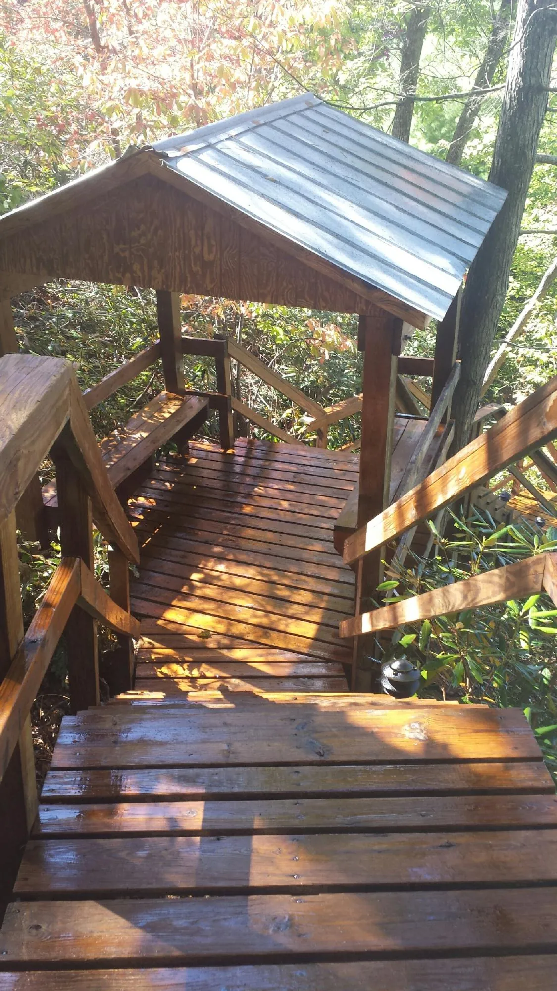 Freshly stained wood walkway and covered shelter with a metal roof in Anna Maria